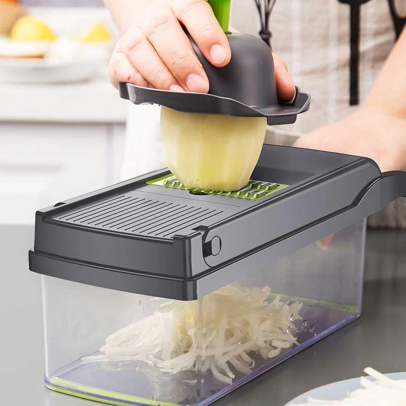 Person using a Multifunctional Vegetable Cutter to slice a potato on a kitchen counter.
