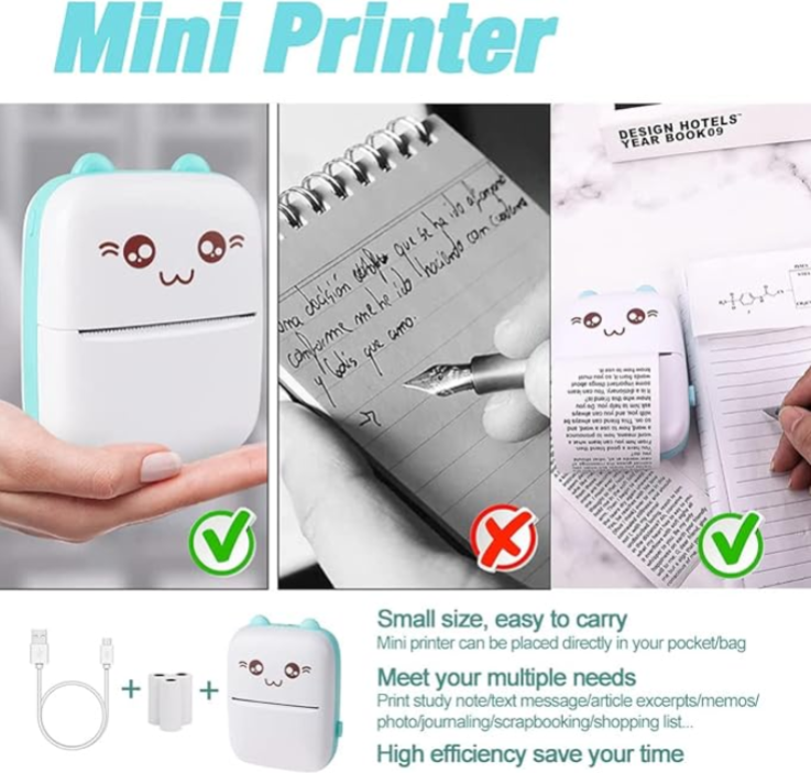 Mini printer with cartoon face held by a hand, used to write on a notebook and a book.